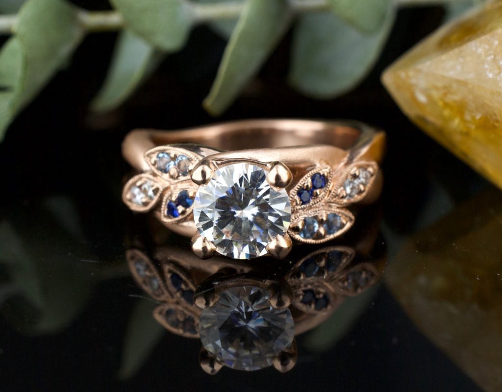 Custom floral inspired engagement ring, rose gold moissanite, aquamarine sapphire, diamond and leaves with a dual finish designed by ASJ