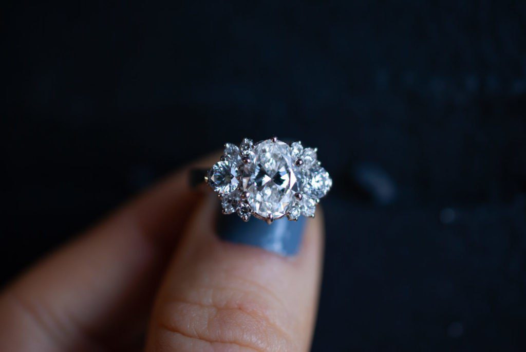 A custom floral inspired engagement ring white gold oval diamond designed by Abby Sparks Jewelry