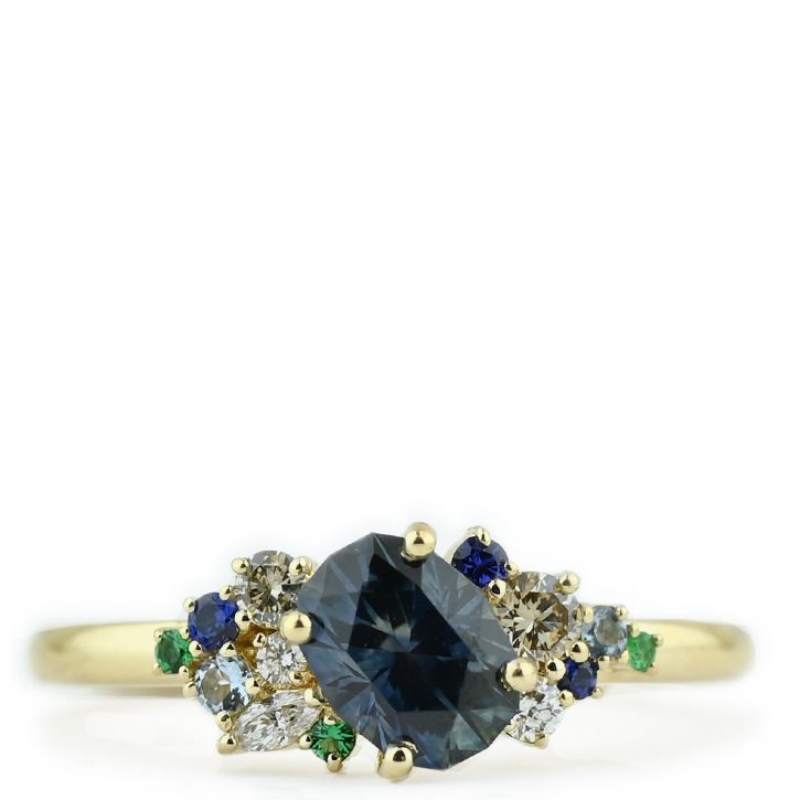 Deep Blue Sapphire Ring with Diamond and Emerald Accents